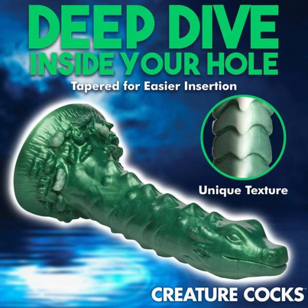 Plongez dans le Monde Envoûtant du gode Cockness Monster Le gode Cockness Monster est un chef-d'œuvre iridescent en forme de dragon.
